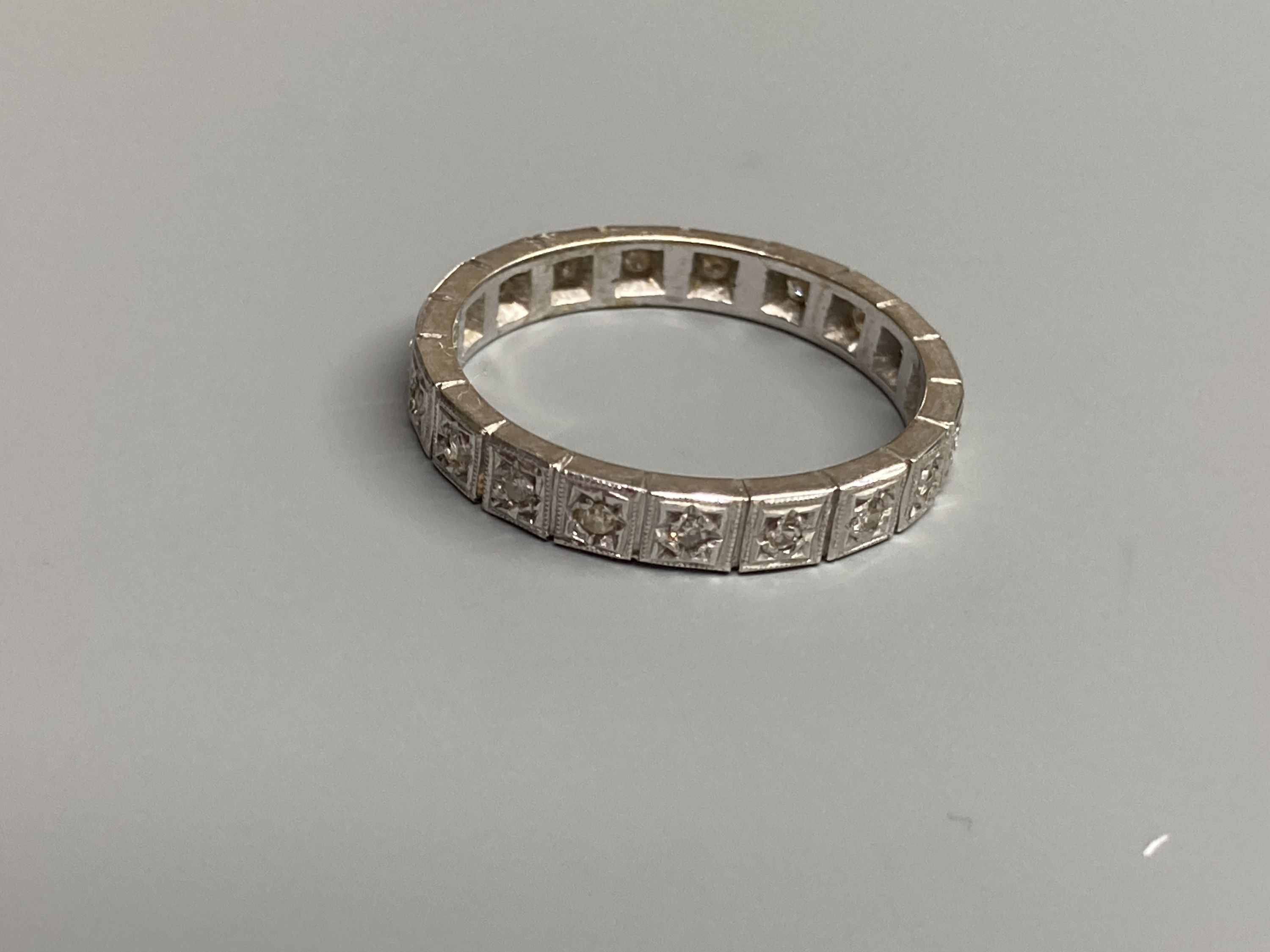 A modern white metal and diamond chip set full eternity ring, total carat weight approx. 0.35ct, size R, gross 4.2 grams.